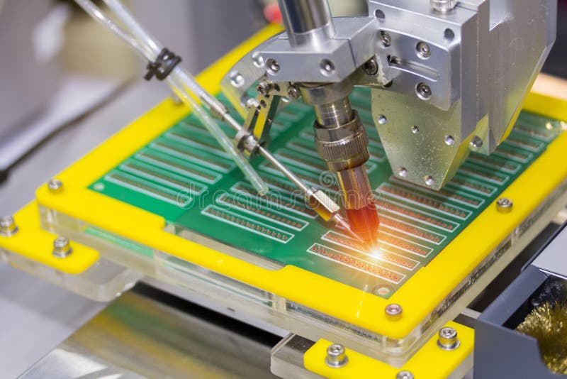 Robotic system for automatic point soldering for printed and assembly electric circuit board PCB at factory stock photo Robotic system for automatic point soldering for printed and assembly electric circuit board PCB at factory stock photo