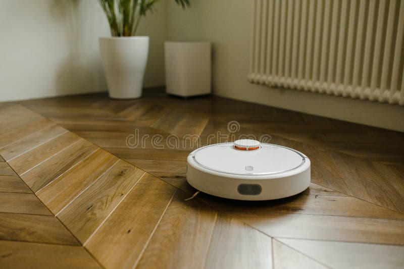 Robotic Vacuum Cleaner On Laminate Wood Floor Smart Cleaning