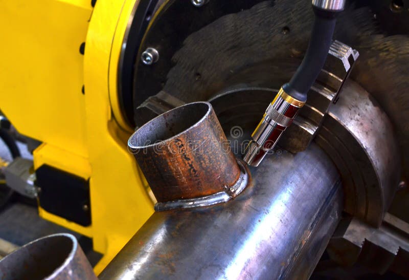 Robotic welder machine in industrial factory, close up - image. Weld seam close-up. stock photos Robotic welder machine in industrial factory, close up - image. Weld seam close-up. stock photos