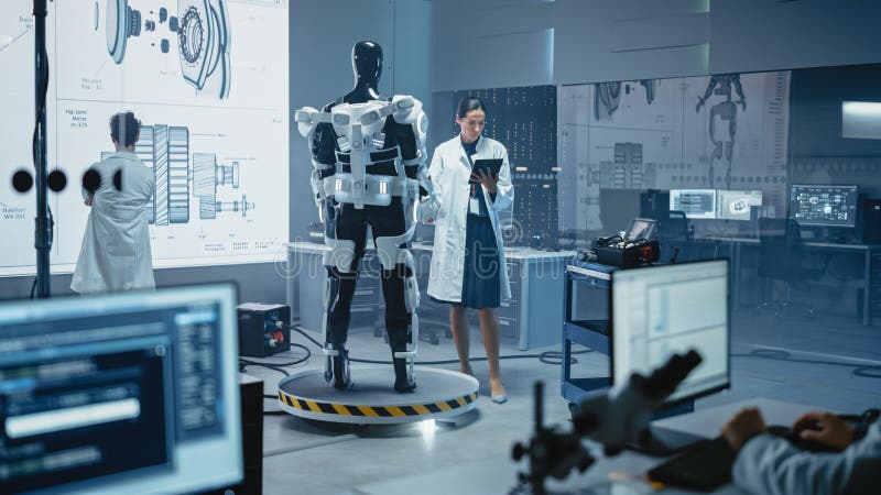 In Robotics Development Laboratory: Female Scientist Uses Digital Tablet Computer, Work on a Robot royalty free stock photos