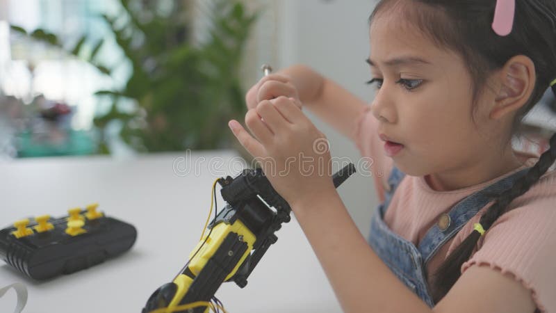 Robotics programming class. Children construct and code Robots. STEM education using constructor blocks and laptop, remote control royalty free stock photo