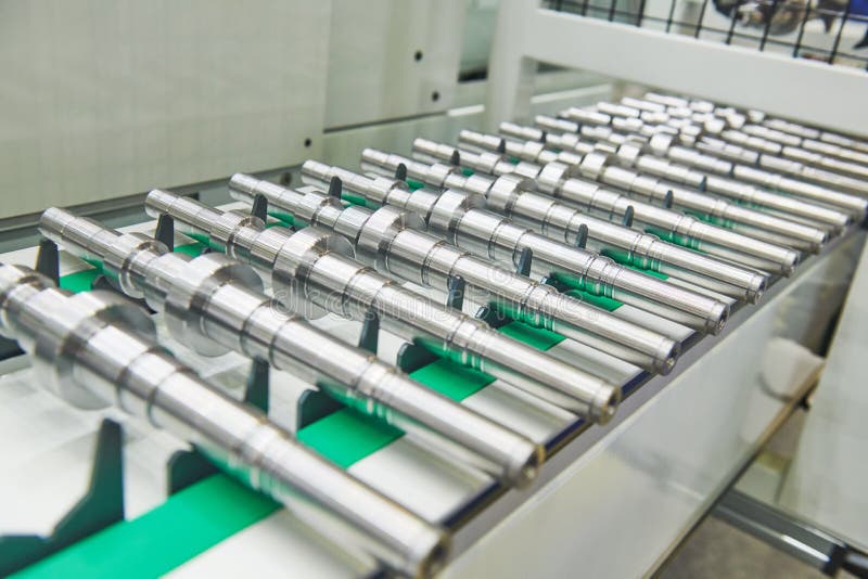 Robotized automated conveyor for detail supply into cnc machining center stock images