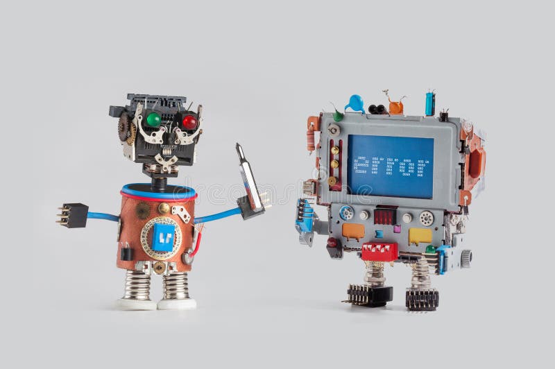 Robots repair service concept. Handyman mechanic worker with driver and robot monitor computer head. Error alert stock image Robots repair service concept. Handyman mechanic worker with driver and robot monitor computer head. Error alert stock image