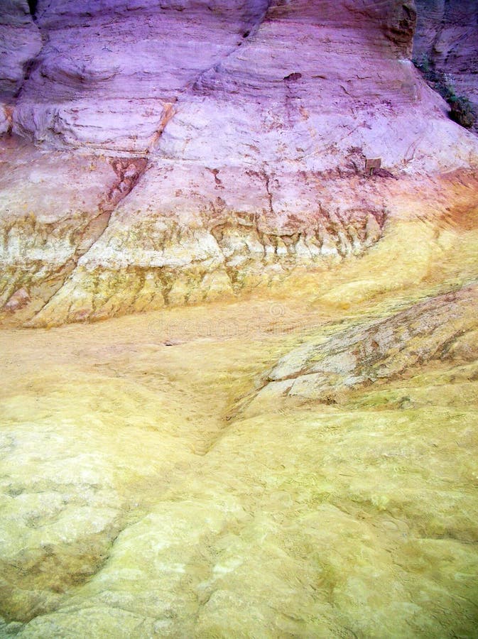 Holes and pockmarks carved by wind and rain in pink sandstone in closeup for background uses. Holes and pockmarks carved by wind and rain in pink sandstone in closeup for background uses