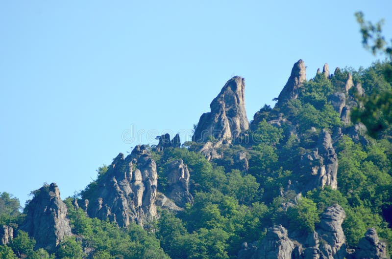 Roches rocailleuses sur une arête de montagne entourée par la forêt photo libre de droits Roches rocailleuses sur une arête de montagne entourée par la forêt photo libre de droits