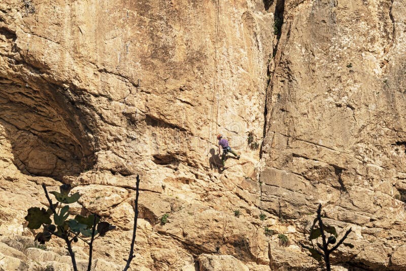 Rock Climber Clinging to a Limestone Cliff in Wadi Qelt stock photos Rock Climber Clinging to a Limestone Cliff in Wadi Qelt stock photos