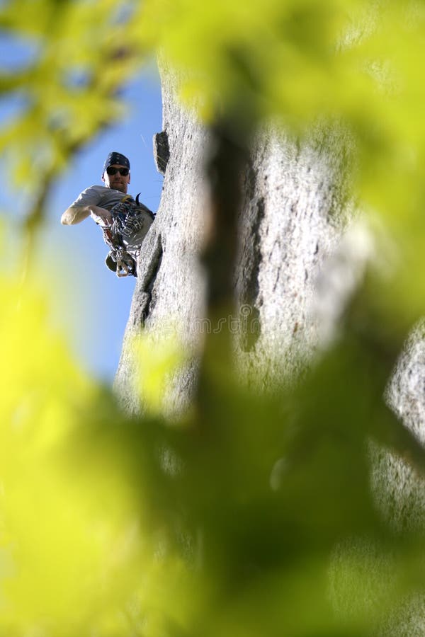 Rock climber through the trees