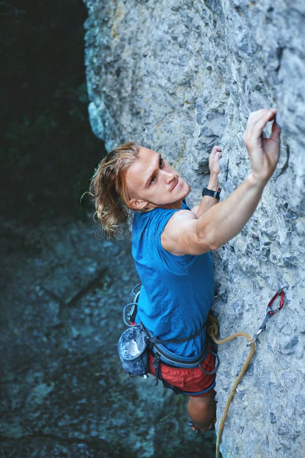 Rock Climbing. Man Rock Climber Climbing the Challenging Route on the ...