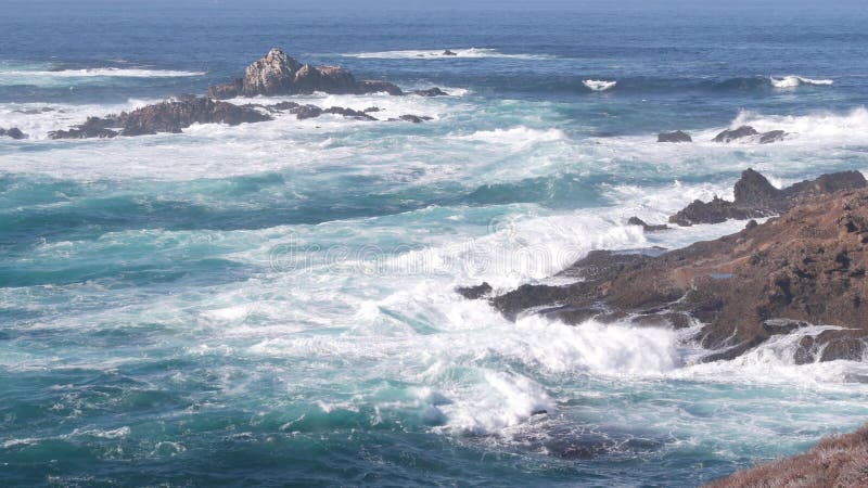 Rock crag of cliff, ocean beach, Point Lobos, California coast. Waves crashing.