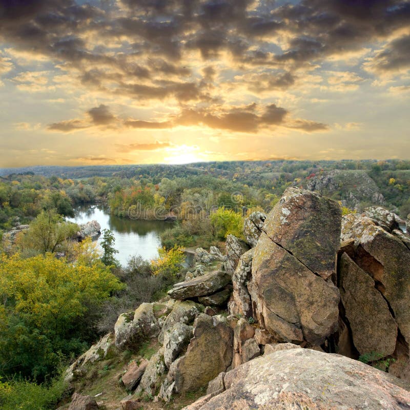 Rock in forest at sunset