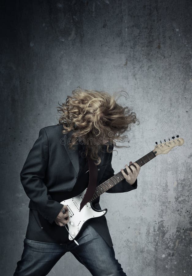 Electric guitar player on a trash background playing the rock music. Metal n stock images, royalty-free photos and pictures