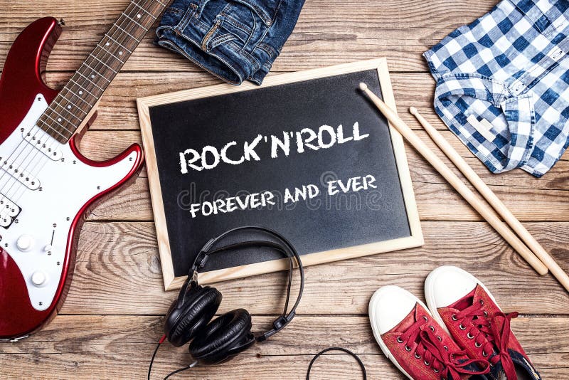 Rock`n`Roll background with blackboard, music equipment, clothes royalty free stock photography Rock`n`Roll background with blackboard, music equipment, clothes royalty free stock photography