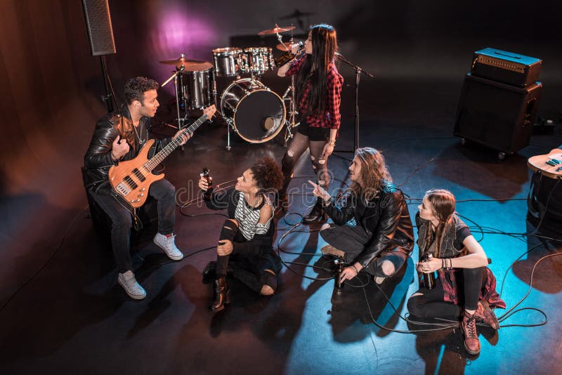 Rock and Roll Band Drinking Beer after Concert on Stage Stock Image