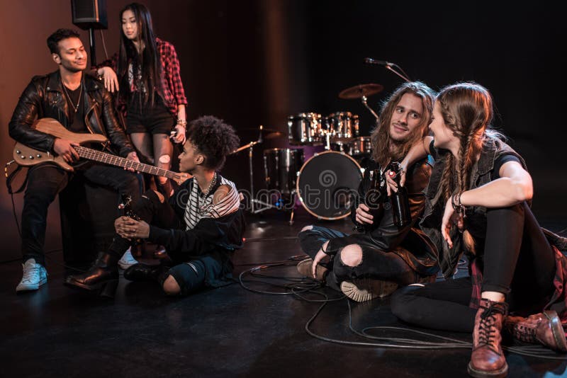 Rock and Roll Band Drinking Beer after Concert on Stage Stock Image