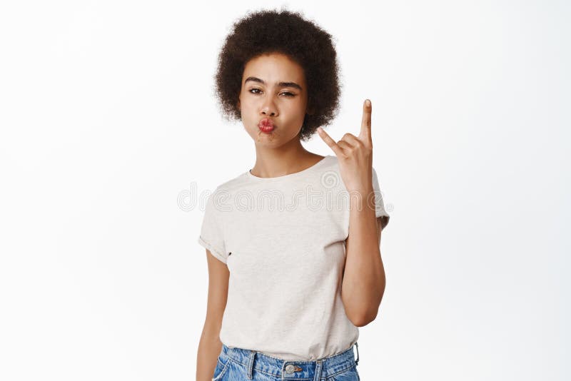 Rock On Smiling African Girl With Afro Hair Showing Sassy Heavy Metal Sign Rock On Gesture