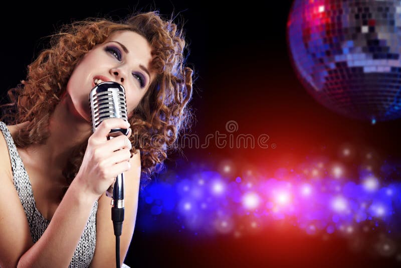 Rock star. Woman singing in retro mic