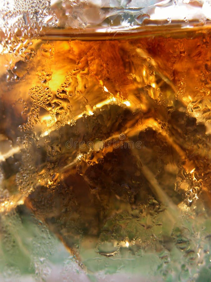 A closeup of a whiskey glass with icecubes. A closeup of a whiskey glass with icecubes.
