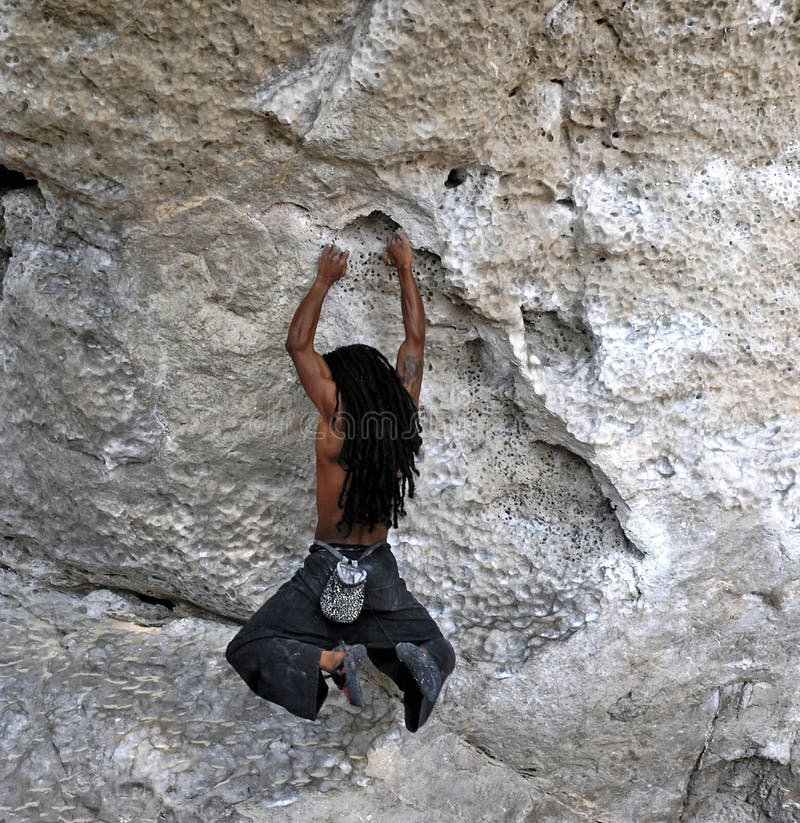 Rockclimber hanging from rock