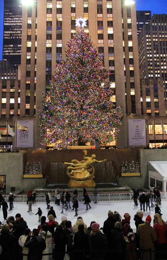 NEW YORK CITY - DEC. 5, 2011: New York City landmark, Ice skaters and tourists on December 5, 2011, visit the famous Rockefeller Center Christmas tree during the holidays. NEW YORK CITY - DEC. 5, 2011: New York City landmark, Ice skaters and tourists on December 5, 2011, visit the famous Rockefeller Center Christmas tree during the holidays.
