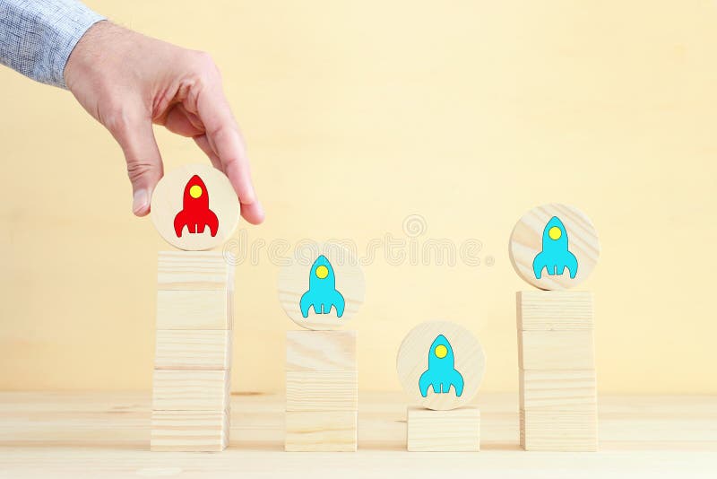 Rocket leadership concept. male hand picking the leader stock images