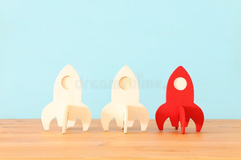 Rocket leadership concept. red rocket as leader of the group. idea of standing out of the crowd stock images
