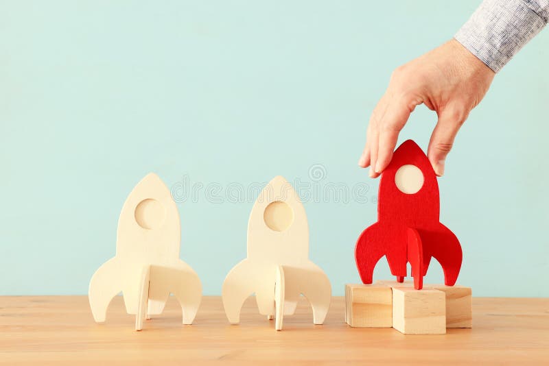 Rocket leadership concept. red rocket as leader of the group. idea of standing out of the crowd stock image