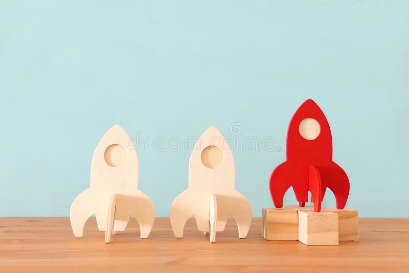 Rocket leadership concept. red rocket as leader of the group. idea of standing out of the crowd stock photos