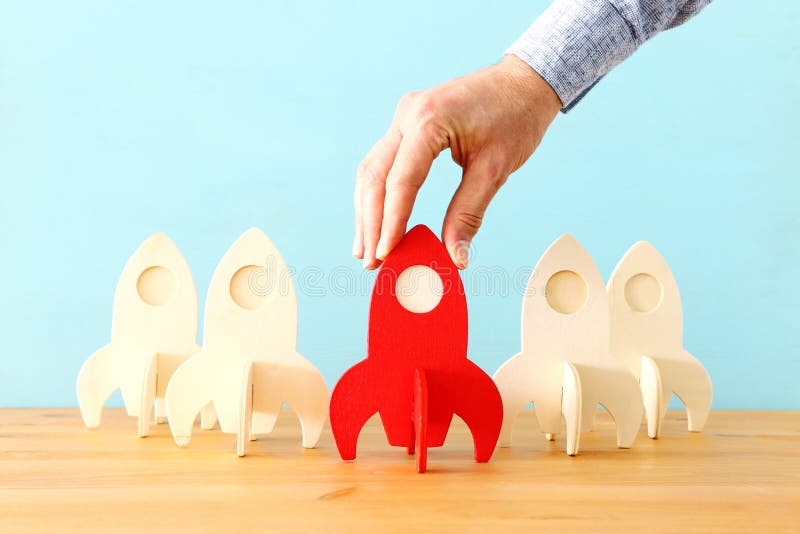 Rocket leadership concept. red rocket as leader of the group. idea of standing out of the crowd stock photo