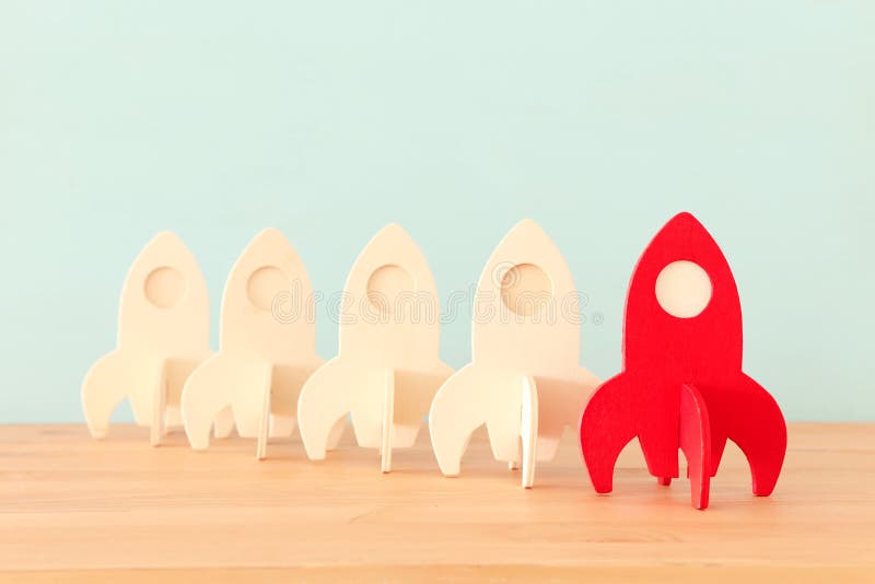 Rocket leadership concept. red rocket as leader of the group. idea of standing out of the crowd stock images