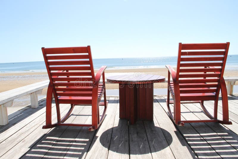 Rocking Chair on the beach stock photo. Image of leisure 25834876