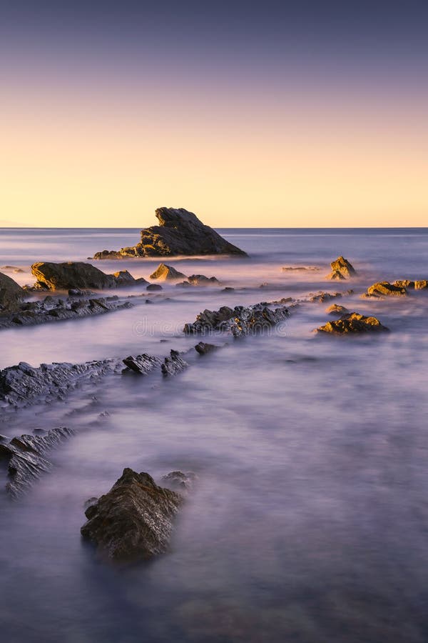 Rocks in a blue ocean in the morning.