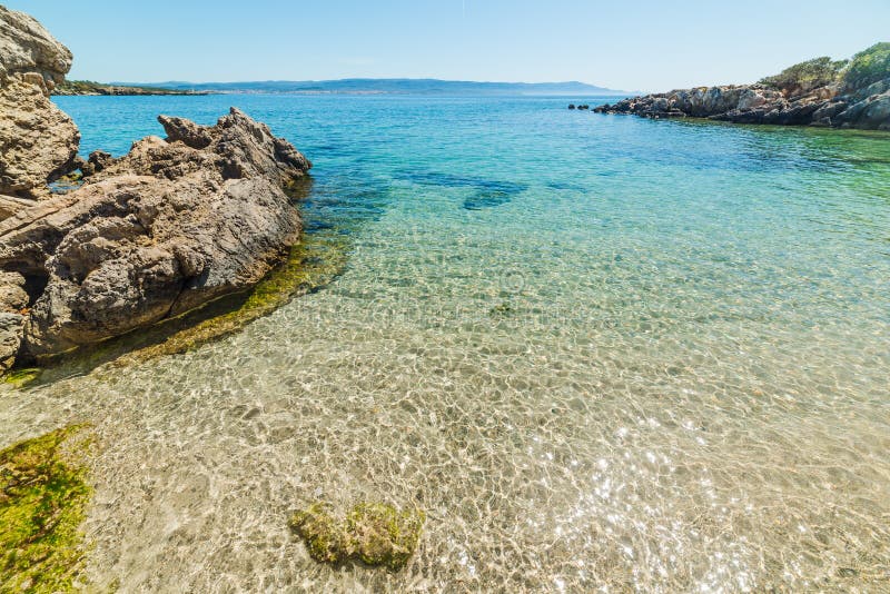 Rocks And Clear Water In A Small Cove In Alghero Stock Photo Image of