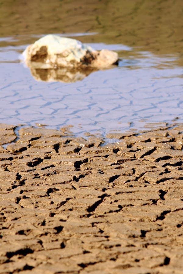 Rocks on cracked ground stock image