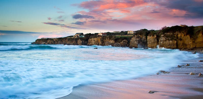 View of a rocky coast in the sunset. Long exposure shot. View of a rocky coast in the sunset. Long exposure shot.