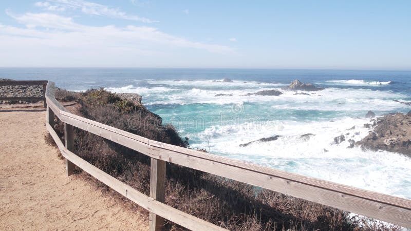 Rock crag of cliff, ocean beach, Point Lobos, California coast. Waves crashing.