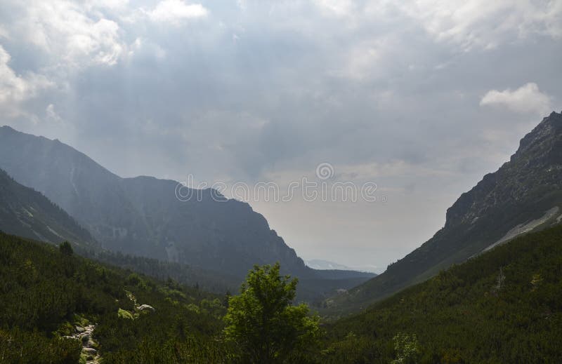 Rocky foggy mountains against cloudy sky in High Tatras, Slovakia