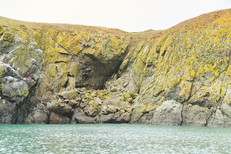 Rocky Island Covered with Moss on the Sea Island Coast. Stock Image