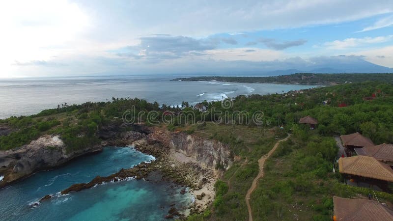 Rocky ledges with green vegetation, houses, paths