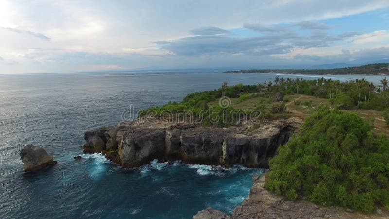 Rocky ledges with green vegetation, houses, paths