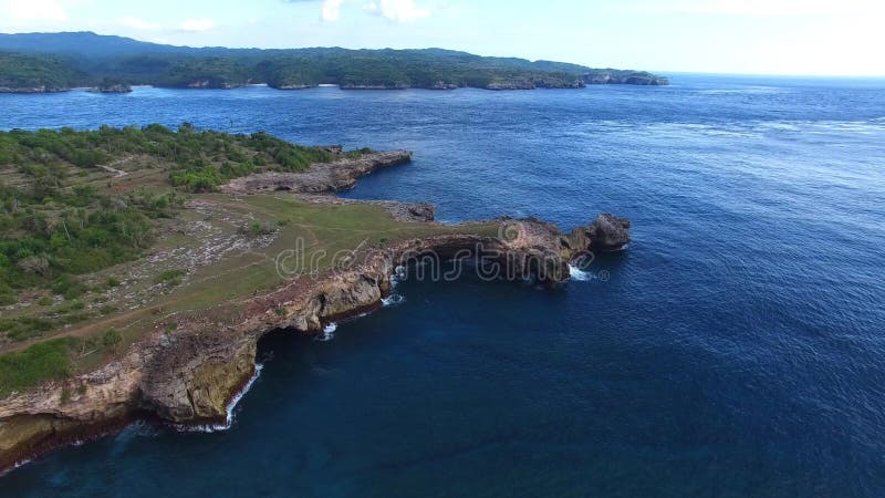 Rocky ledges with green vegetation, houses, paths