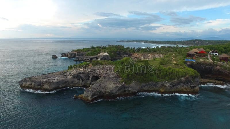 Rocky ledges with green vegetation, houses, paths