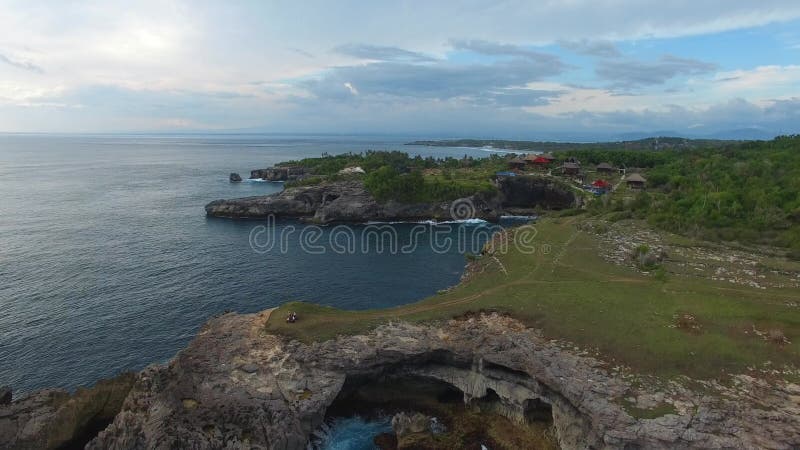 Rocky ledges with green vegetation, houses, paths