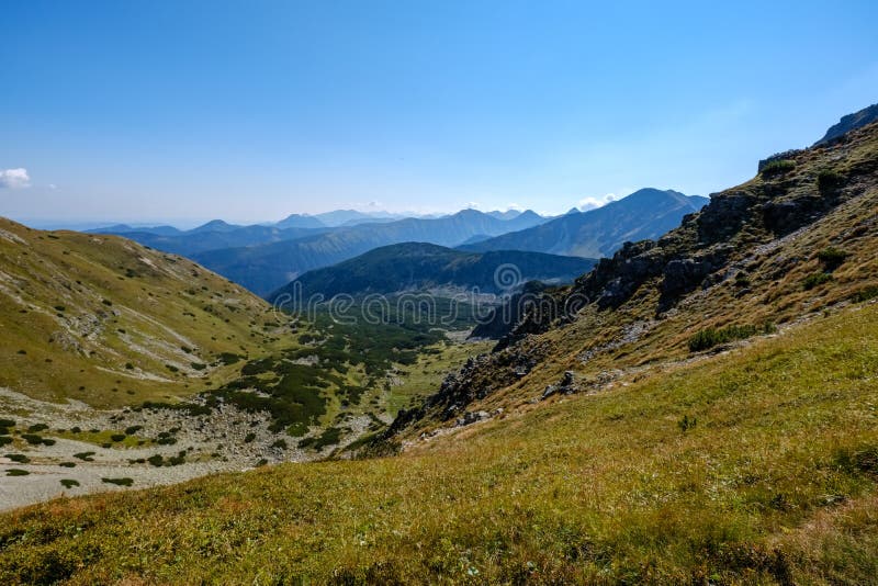 Skalnaté vrcholky hor s turistickými stezkami na podzim ve slovenském Ta