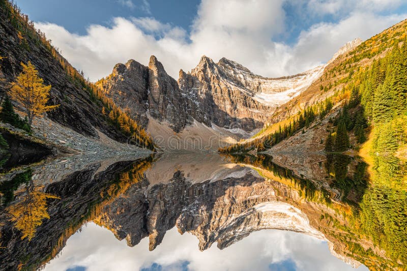 Rocky mountains in autumn forest reflection on Lake Agnes Tea House in Banff national park, Alberta, Canada. Rocky mountains in autumn forest reflection on Lake Agnes Tea House in Banff national park, Alberta, Canada