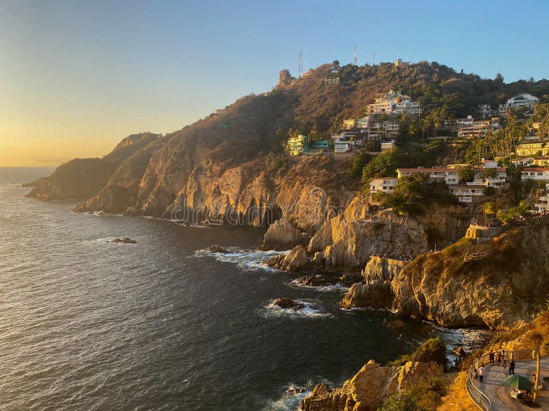 Rocky ocean cliffside during sunset stock image