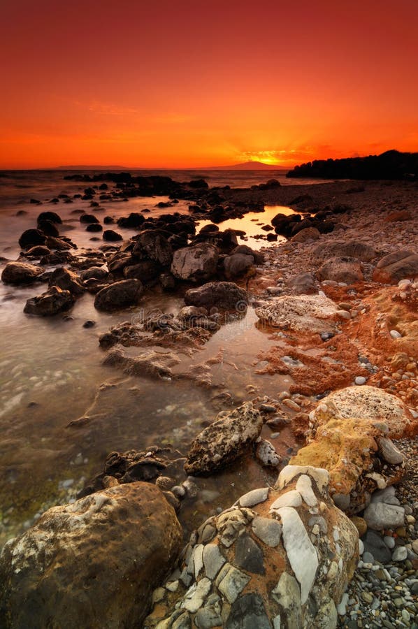 Spectacular sunset over a dramatic rocky seascape in Mani peninsula, southern Greece. Roughness stock images, royalty-free photos and pictures