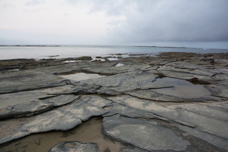 Rocky shore line at sunset stock image. Image of rocky 94221991