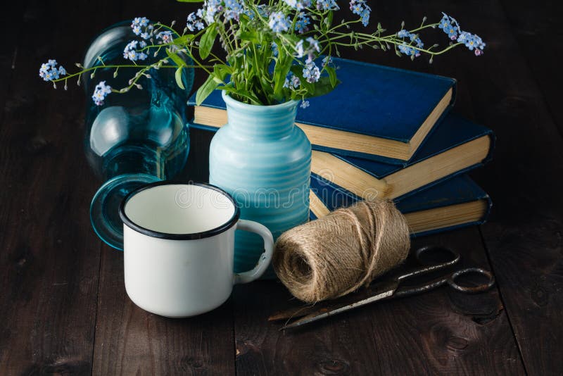 Vintage books on table with forget me not flowers. nostalgia concept. Vintage books on table with forget me not flowers. nostalgia concept