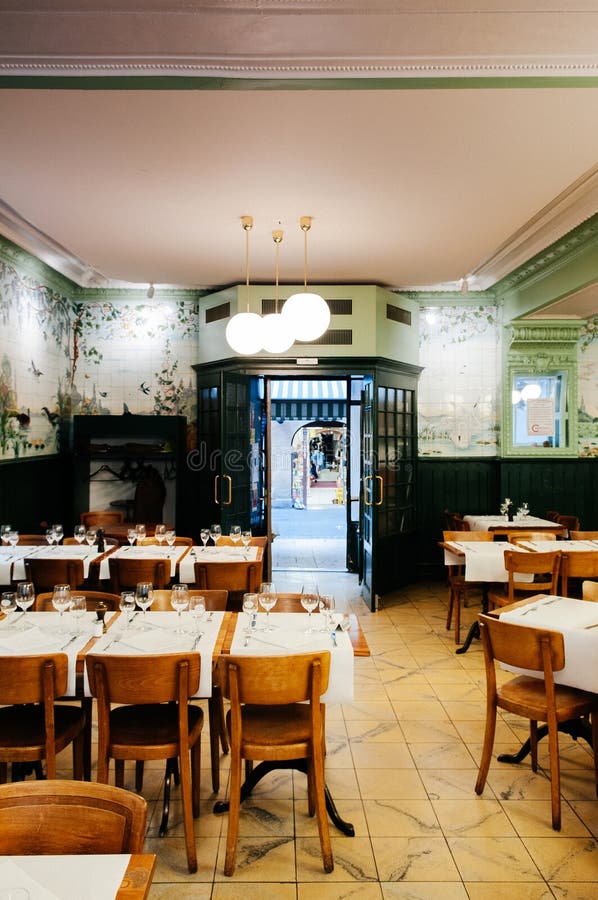 SEP 26, 2013 Neuchatel, Switzerland - Brasserie Le Cardinal old vintage restaurant with wooden table, chair and art nouveau wall painting interior. Famous old time dinner place in Neuchatel since 1902. SEP 26, 2013 Neuchatel, Switzerland - Brasserie Le Cardinal old vintage restaurant with wooden table, chair and art nouveau wall painting interior. Famous old time dinner place in Neuchatel since 1902