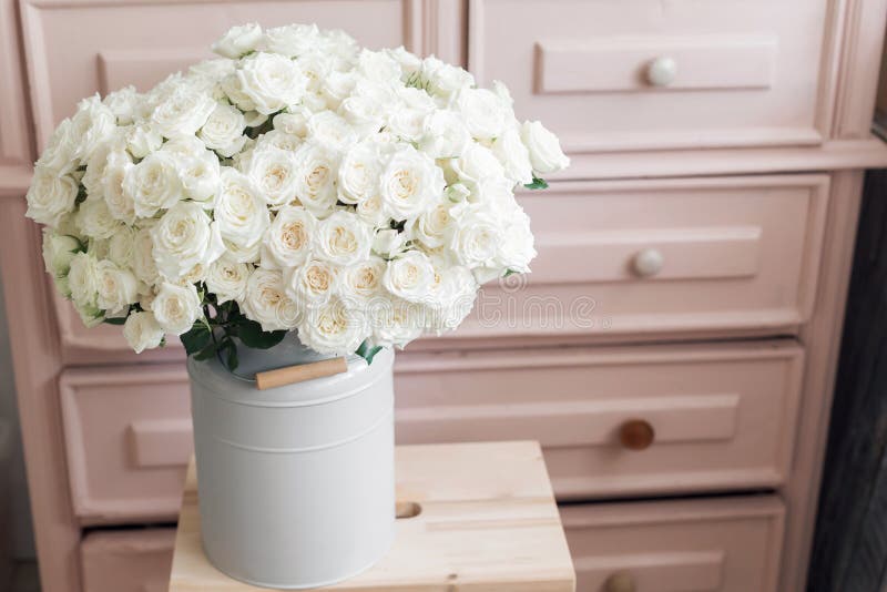 Vintage interior decoration pink pastel closet white roses in metal bucket. flower shop. Vintage interior decoration pink pastel closet white roses in metal bucket. flower shop